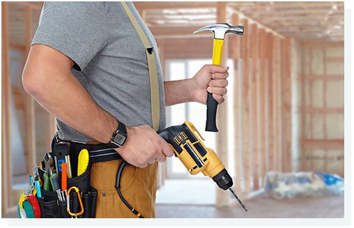 Builder handyman with drill and hammer